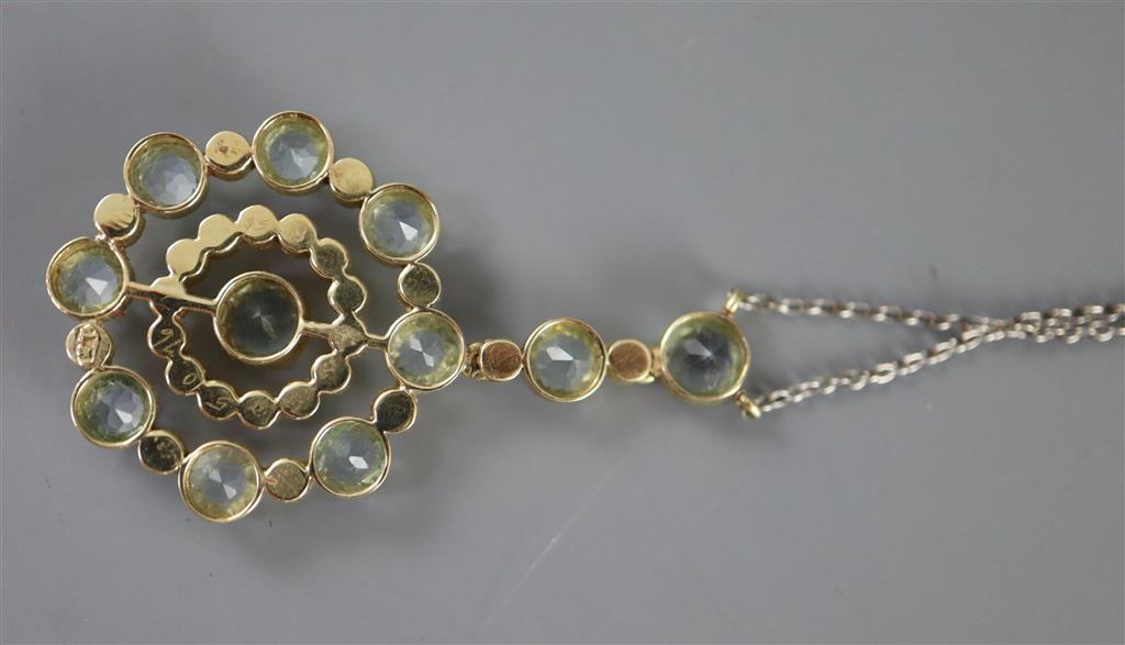 An Edwardian 15ct gold, aquamarine and seed pearl set circular drop pendant necklace,